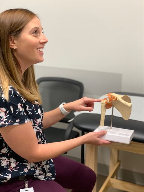 jessica cullen showing an anatomy model to patient